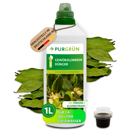 Purgrün Bio-Gewürzlorbeer-Dünger, 1 Liter, in weißer Flasche mit Dosierkappe, umgeben von Lorbeerblättern.