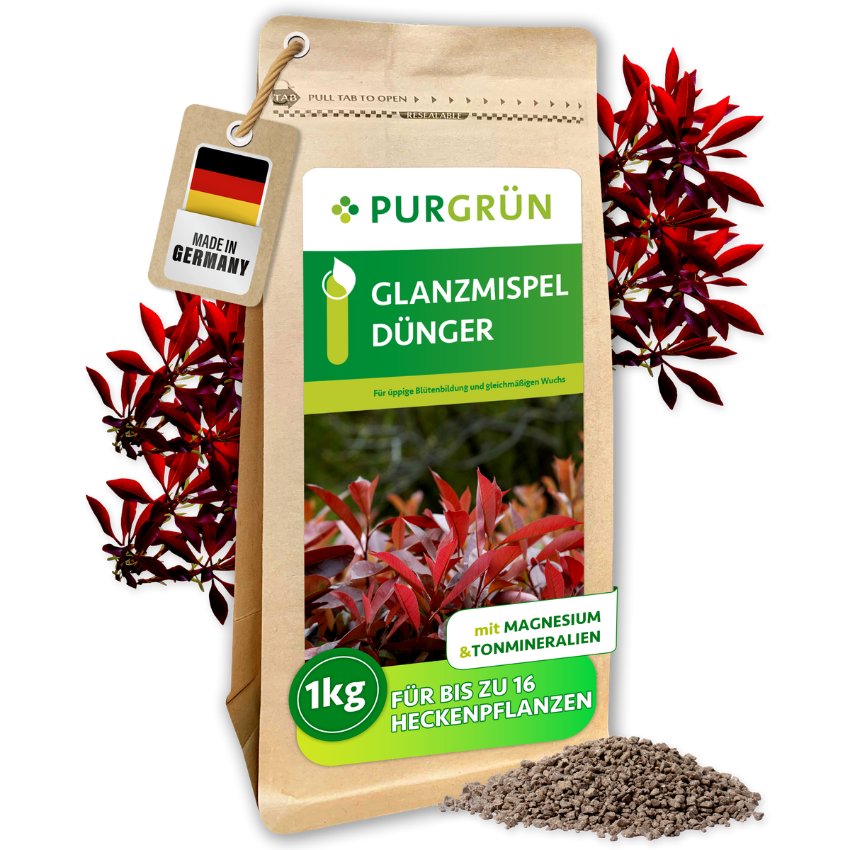 Purgrün Glanzmispel-Dünger im 1-kg-Beutel, umgeben von roten Glanzmispelzweigen und feinem Granulat.