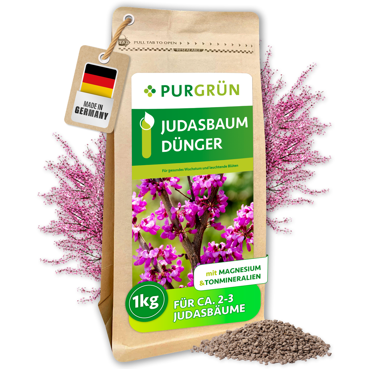 Purgrün Judasbaum-Dünger im 1-kg-Standbeutel mit sichtbarem Granulat und rosafarben blühendem Judasbaum.