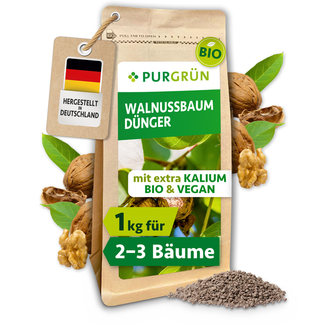 Purgrün Bio-Walnussbaum-Dünger im 1-kg-Beutel, umgeben von Walnüssen, grünen Blättern und feinem Granulat.